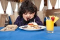 Ecstatic young boy eating a stack of pancakes Royalty Free Stock Photo