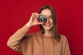 Ecstatic young woman covers one eye with a compass for life decisions. Royalty Free Stock Photo