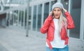 Ecstatic young woman talks on the smartphone. Outdoors daylight. Pleased amazing girl using the mobile phone