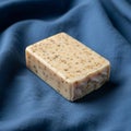 Ectangular bar of soap with a creamy beige color, speckled with Royalty Free Stock Photo