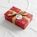 Ectangular gift box wrapped in red paper decorated with gold snowflake Royalty Free Stock Photo