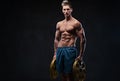 Ectomorph shirtless athletic male holds barbell weight.