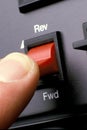 Ectreme close up of finger on switch indicating forward and reverse Royalty Free Stock Photo