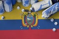 Ecuador flag and few used aerosol spray cans for graffiti painting. Street art culture concept