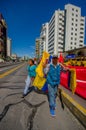 Ecuadorian flag salesman walking in sunny city