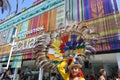 Ecuadorian folklore dancer is posing with a big decorative wheel feather ornamental hat on her head in a sunny summer day.