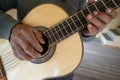 Ecuadorian luthier hands on guitar