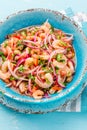 Ecuadorian shrimps ceviche sebiche with tomatoes in blue bowl, wooden blue background. Traditional ecuadorian colombian Royalty Free Stock Photo