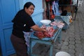 Ecuadorian woman cutting meat