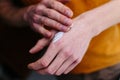 Ointment on the hands of an elderly person. Retired applying the ointment , creams in the treatment of eczema, psoriasis and other