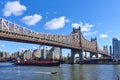 The Ed Koch Queensboro Bridge where it passes over the East River with a barge Royalty Free Stock Photo