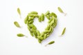 edamame in pod forming a heart shape, white surface