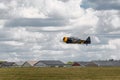 AT-6 Texan Flies Low Over Runway with Hangers