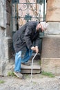 Ederly man in protective mask  with a cane descends down the stairs Royalty Free Stock Photo