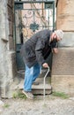 Ederly man in protective mask  with a cane descends down the stairs Royalty Free Stock Photo