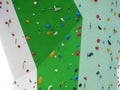 Edge of climbing wall with colorful resin holds Royalty Free Stock Photo