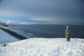 On the edge of the earth, north of Russia, the Arctic Ocean shore. Contrast of overall nature and small man. Beautiful snowy view