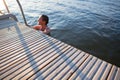 Edge of pier with woman in water