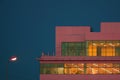 Edge of pink building with roof on the background of the blue sky in clear weather. Minimalism, abstract and conceptual photo Royalty Free Stock Photo