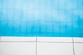 Edge of swimming pool with white tiles