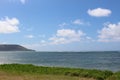 Green Grass Ocean and Blue Skies Royalty Free Stock Photo