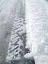 The edge of the winter road. Tyre tracks imprinted into snow Royalty Free Stock Photo