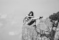 On edge of world. Woman sit on edge of cliff in high mountains blue sky background. Hiking peaceful moment. Enjoy the Royalty Free Stock Photo