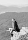 On edge of world. Woman sit on edge of cliff in high mountains landscape background. Hiking peaceful moment. Enjoy the Royalty Free Stock Photo