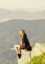 On edge of world. Woman sit on edge of cliff in high mountains landscape background. Hiking peaceful moment. Enjoy the Royalty Free Stock Photo