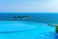 Edgeless swimming pool in front of ocean Royalty Free Stock Photo