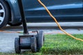 Edger kicking grass up in the air as a middle aged man edges the grass on a sunny winter afternoon Royalty Free Stock Photo