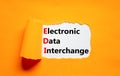 EDI electronic data interchange symbol. Concept words EDI electronic data interchange on white paper on a beautiful orange Royalty Free Stock Photo