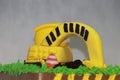 Edible Alloy Excavator Truck Car Vehicles and pile of soil with traffic cone on the chocolate cake