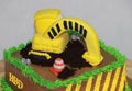 Edible Alloy Excavator Truck Car Vehicles and pile of soil with traffic cone on the chocolate cake. And text HBD