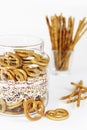 Edible dry snacks sticks and bagels in a decorative jar