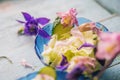 Edible flowers salad in a plate on blue wooden table with fork Royalty Free Stock Photo