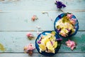 Edible flowers salad in a plate on blue wooden table with fork Royalty Free Stock Photo