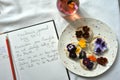 Edible flowers snacks with flower tea as a healthy and happy breakfast with journal and pen