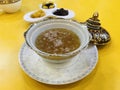 Edible maroon Bird`s nest soup in benjarong bowl served with sweetened side dish in Royalty Free Stock Photo