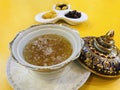 Edible maroon Bird`s nest soup in benjarong bowl served with sweetened side dish in Royalty Free Stock Photo