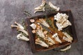 Edible raw white and brown beech mushrooms with thyme and garlic for cooking on a kitchen cutting board. horizontal top view Royalty Free Stock Photo