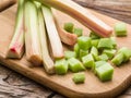 Edible rhubarb stalks on the wood.