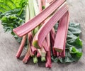 Edible rhubarb stalks on the wooden table