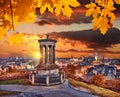 Edinburgh with Calton Hill against autumn leaves in Scotland