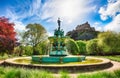 Edinburgh Castle in blue sky, sun and clouds and Ross Fountain, Scotland - UK Royalty Free Stock Photo