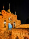 Edinburgh castle at night with the historic red Lion rampant crest - Translation of the latin Nemo me impune lacessit