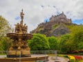 Edinburgh Castle and Ross Fountain seen from the Princes Street Gardens on a bright sunny day. Royalty Free Stock Photo