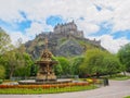 Edinburgh Castle and Ross Fountain seen from the Princes Street Gardens on a bright sunny day. Royalty Free Stock Photo