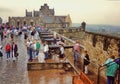 Edinburgh Castle, in Edinburgh, Scotland. Visitors looking over the cannon