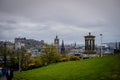 Edinburgh City and Castle, Scotland, viewed from Calton Hill on a cloudy afternoon with the Dugald Stewart monument in Royalty Free Stock Photo